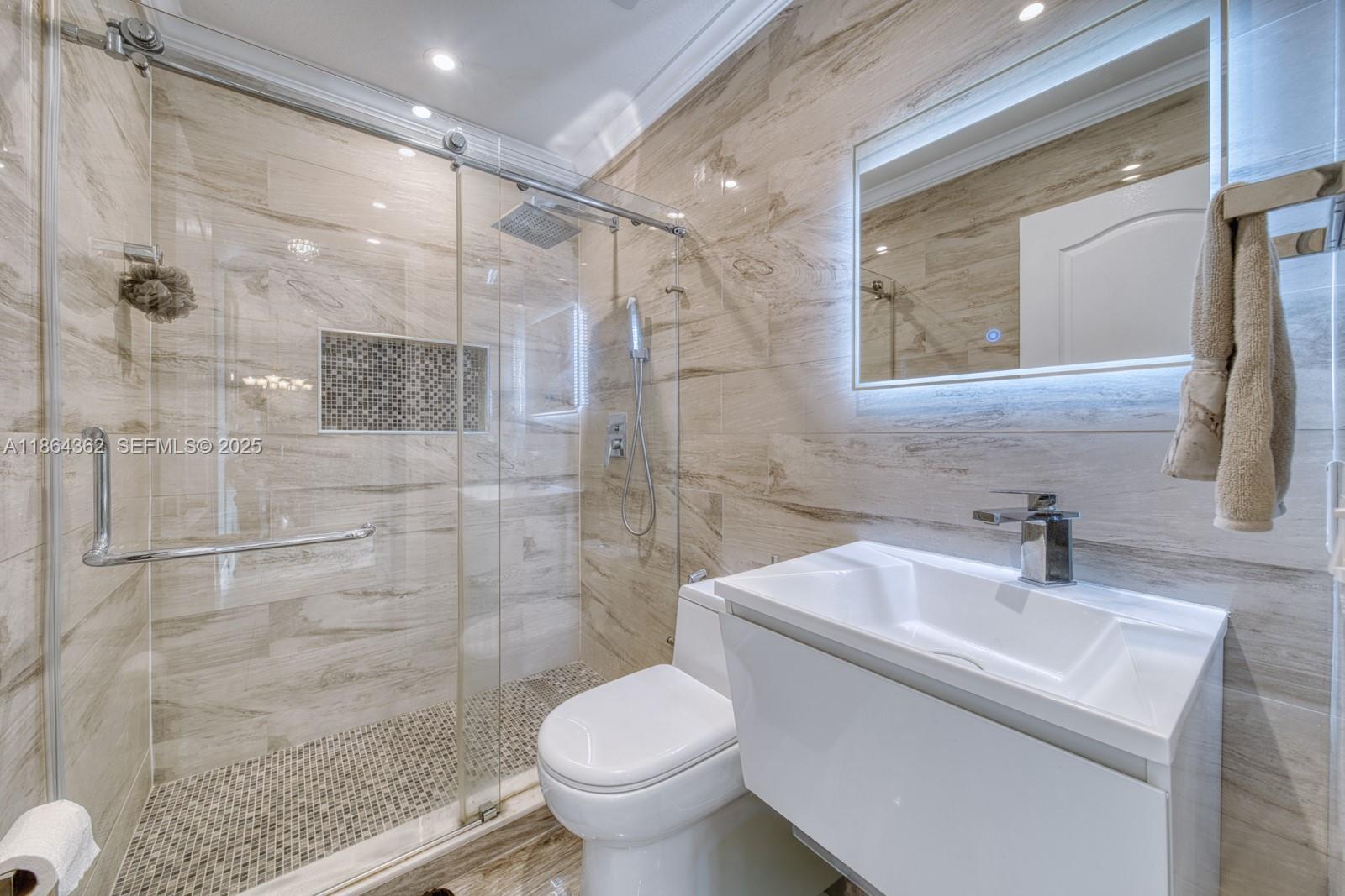 16886 Southwest 143rd Place Miami, FL 33177 - Photo 27 of 39 a bathroom with a sink toilet and shower