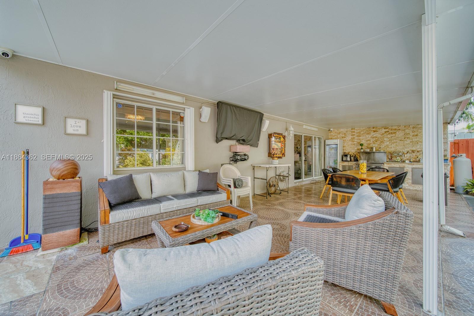 16886 Southwest 143rd Place Miami, FL 33177 - Photo 32 of 39 a living room with furniture and a table