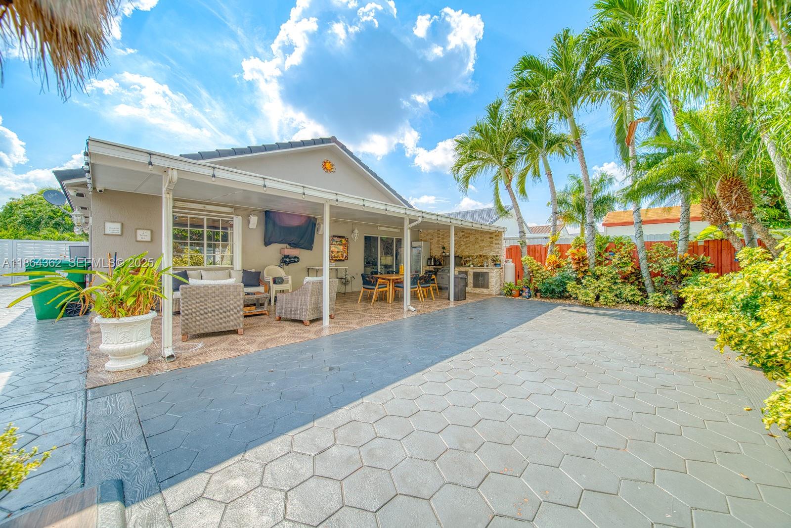 16886 Southwest 143rd Place Miami, FL 33177 - Photo 33 of 39 a view of a house with backyard and sitting area