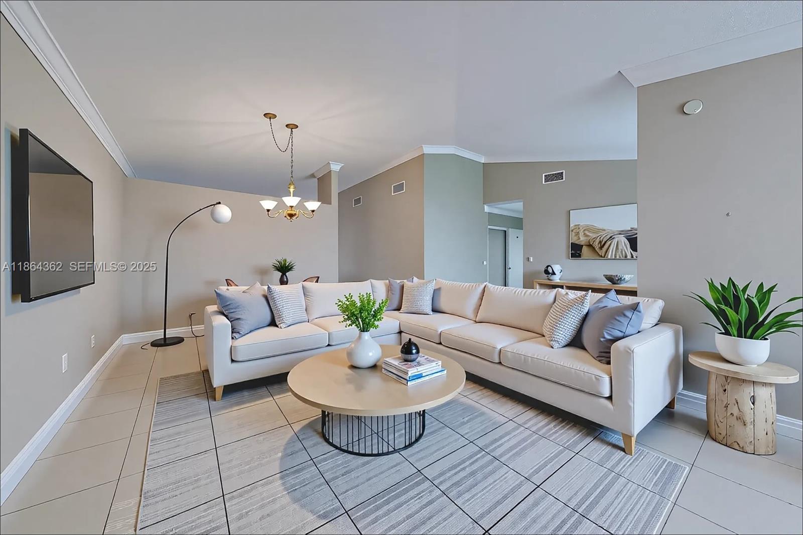 16886 Southwest 143rd Place Miami, FL 33177 - Photo 8 of 39 a living room with fireplace furniture and a chandelier