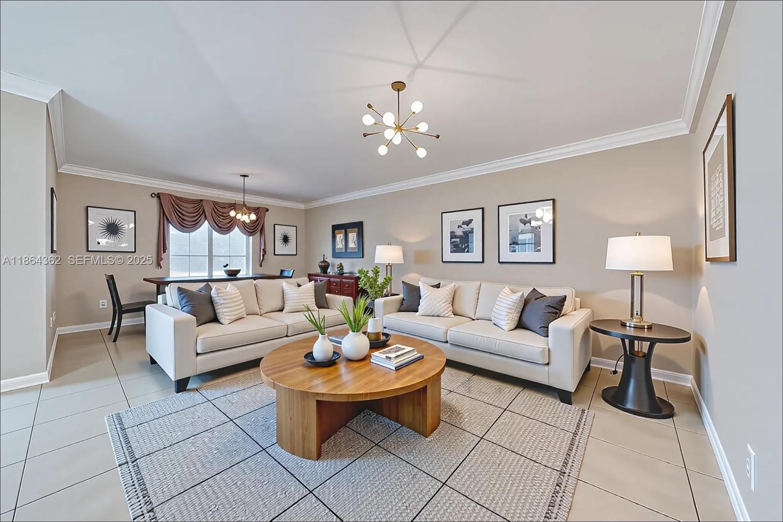 16886 Southwest 143rd Place Miami, FL 33177 - Photo 9 of 39 a living room with furniture a lamp and a chandelier