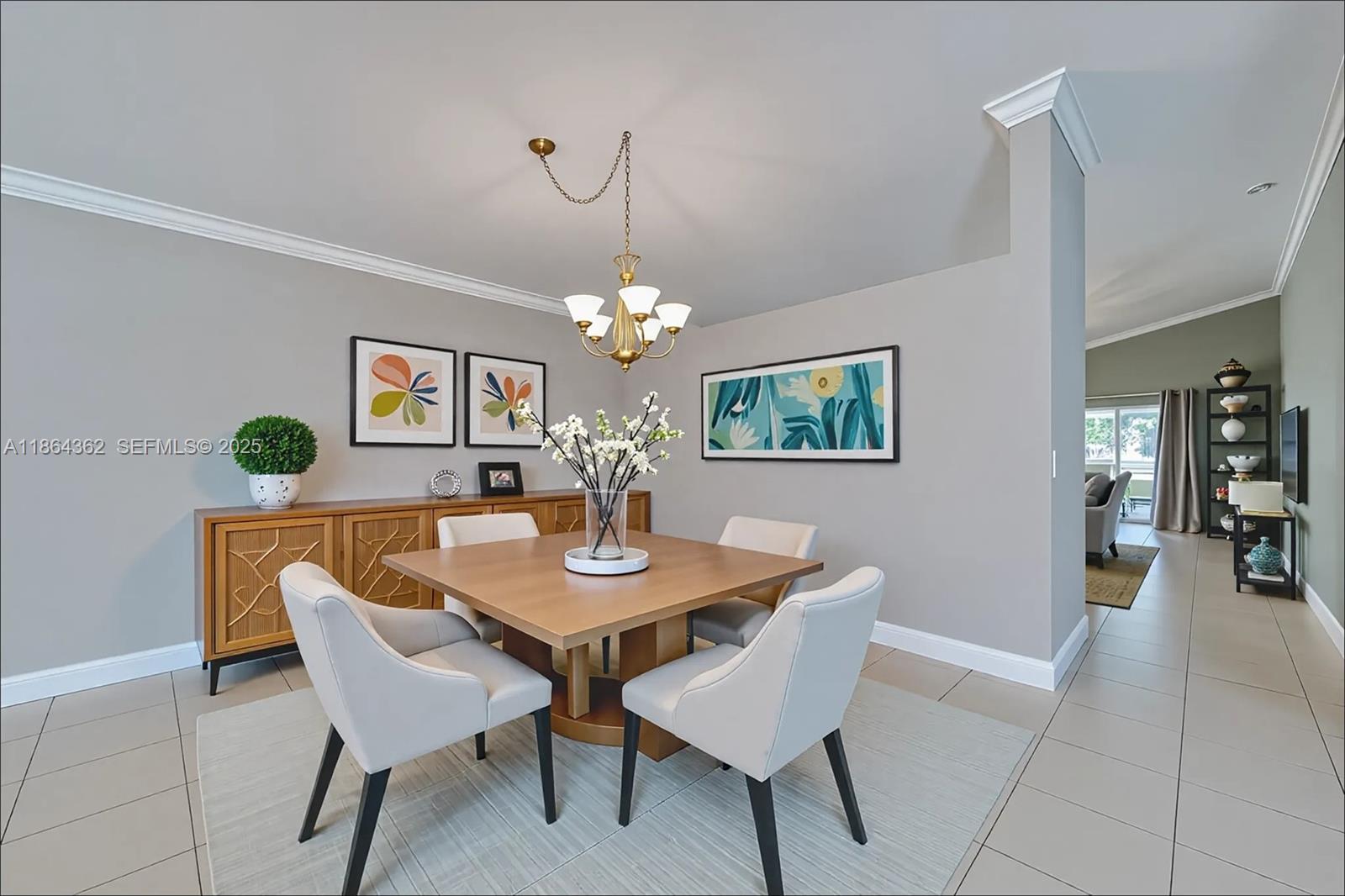 16886 Southwest 143rd Place Miami, FL 33177 - Photo 10 of 39 a view of a dining room with furniture and chandelier