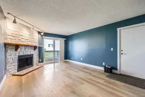 a view of empty room with a fireplace