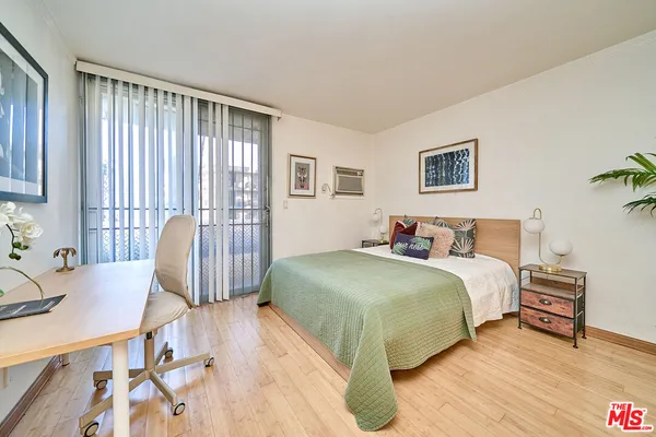 a spacious bedroom with a bed and a table in it