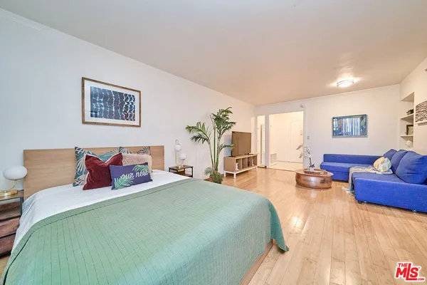 a bedroom with bed and a couch