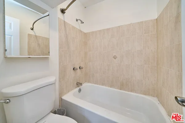a bathroom with a toilet a sink and bathtub