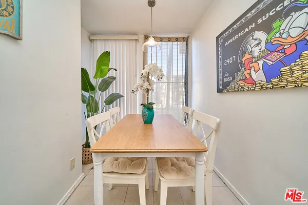 a view of a dining room with furniture and a potted plant