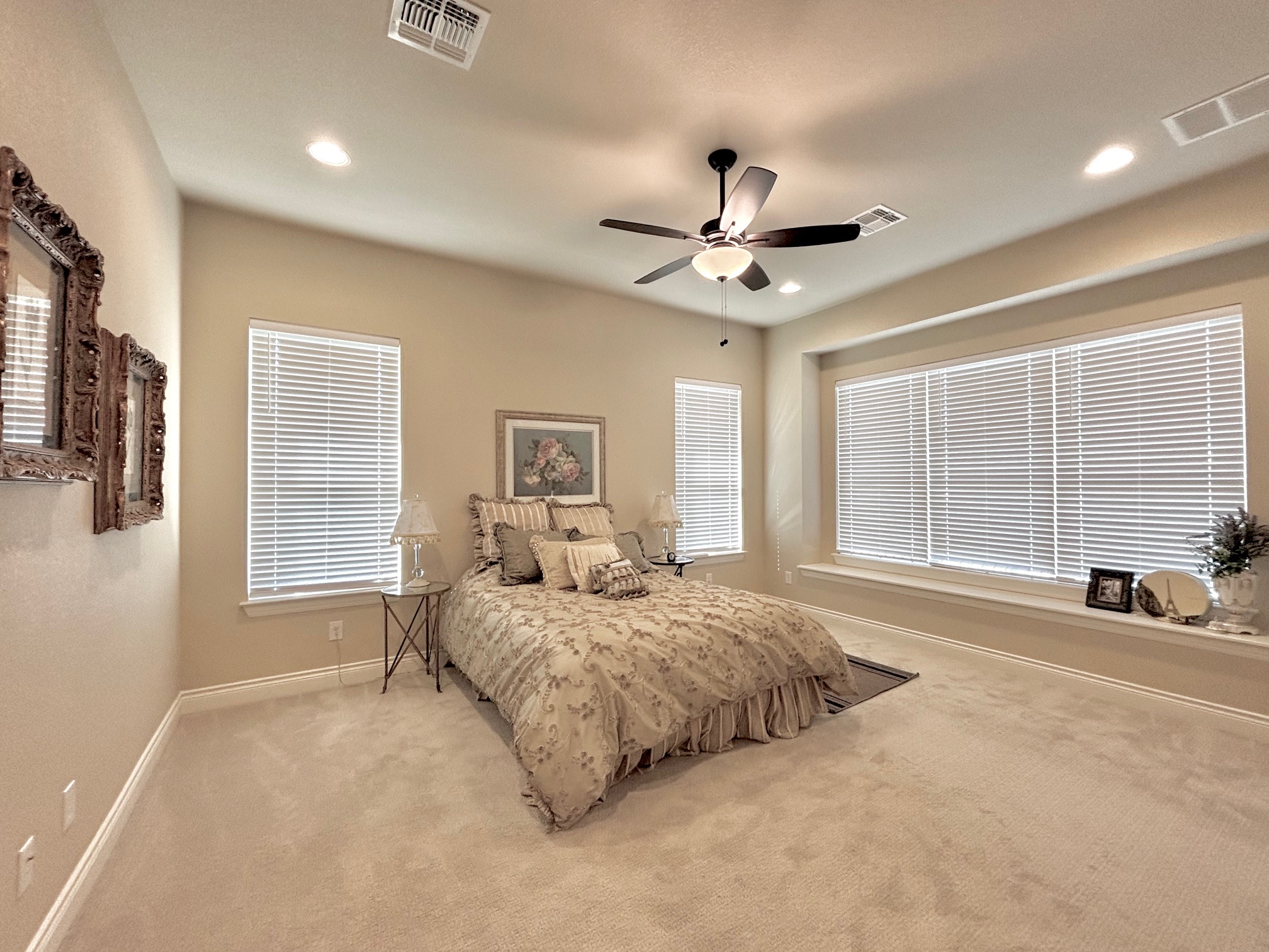 820 Desaix Drive Georgetown, TX 78628 - Photo 19 of 35 a spacious bedroom with a large bed a chandelier and windows