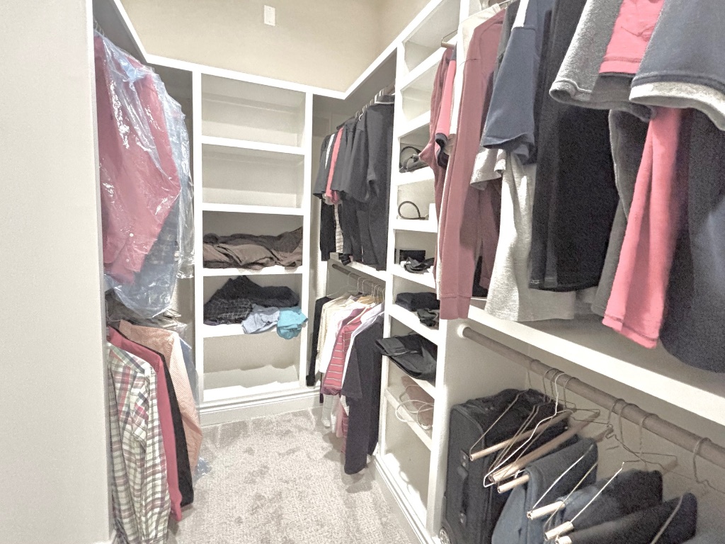 820 Desaix Drive Georgetown, TX 78628 - Photo 24 of 35 a view of walk in closet with clothes and shoes