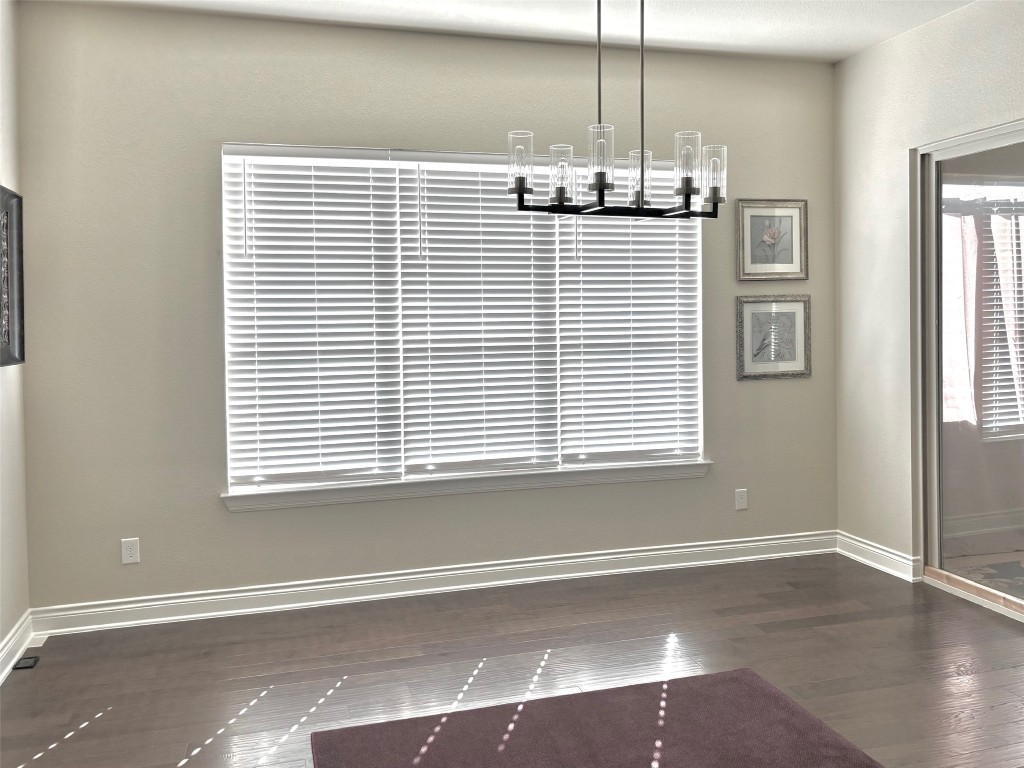 820 Desaix Drive Georgetown, TX 78628 - Photo 7 of 35 an empty room with wooden floor and windows