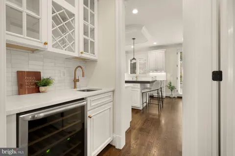 a kitchen with kitchen island granite countertop a sink a counter space appliances and cabinets
