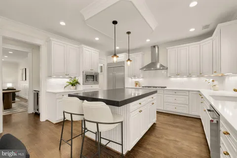 a kitchen with stainless steel appliances kitchen island granite countertop a sink and cabinets