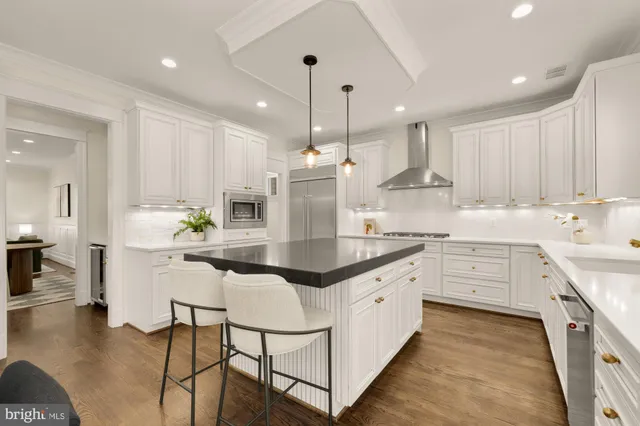 a kitchen with stainless steel appliances kitchen island granite countertop a sink and cabinets