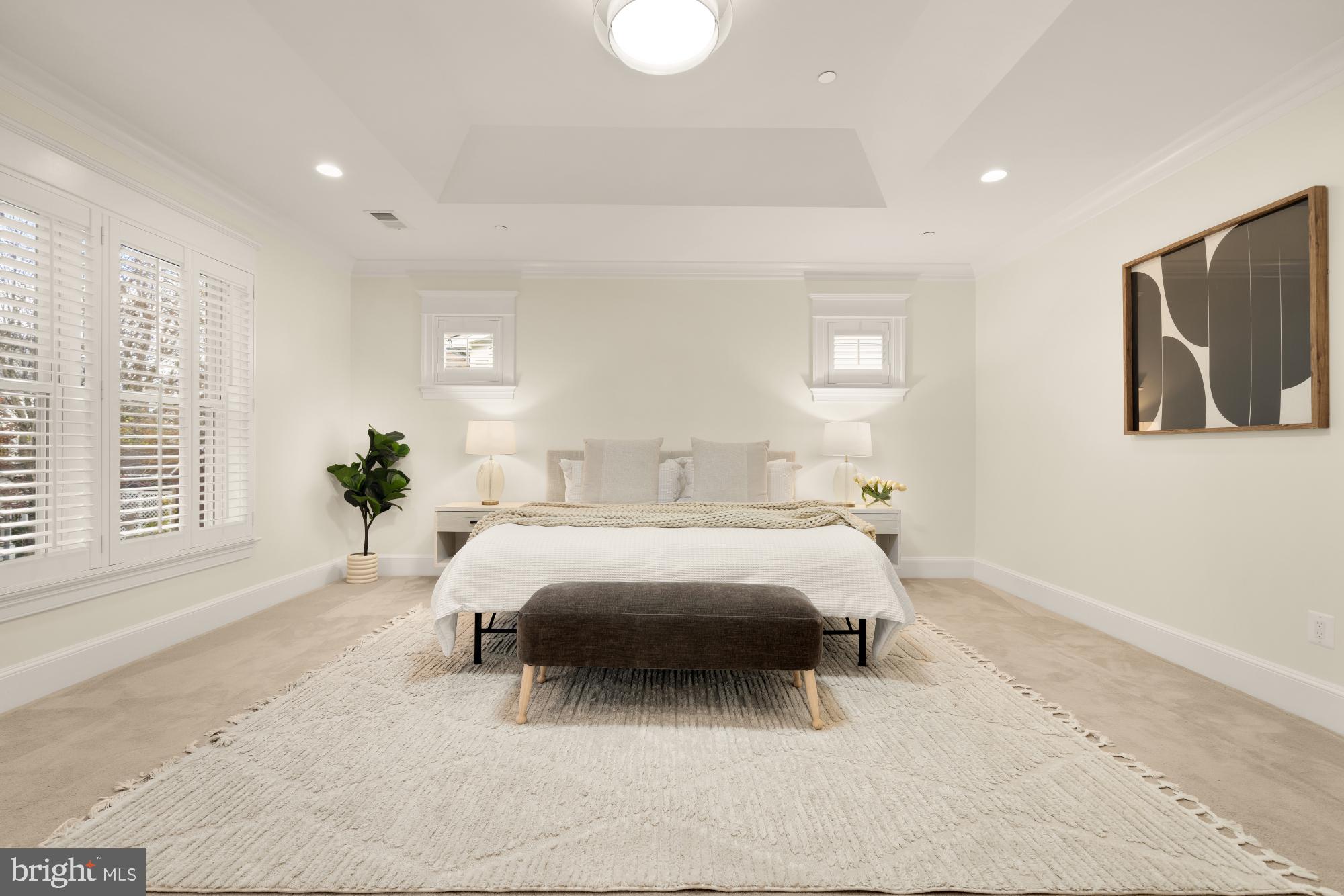 4609 Glenbrook Parkway Bethesda, MD 20814 - Photo 26 of 62 a spacious bedroom with a bed a couch and a large window