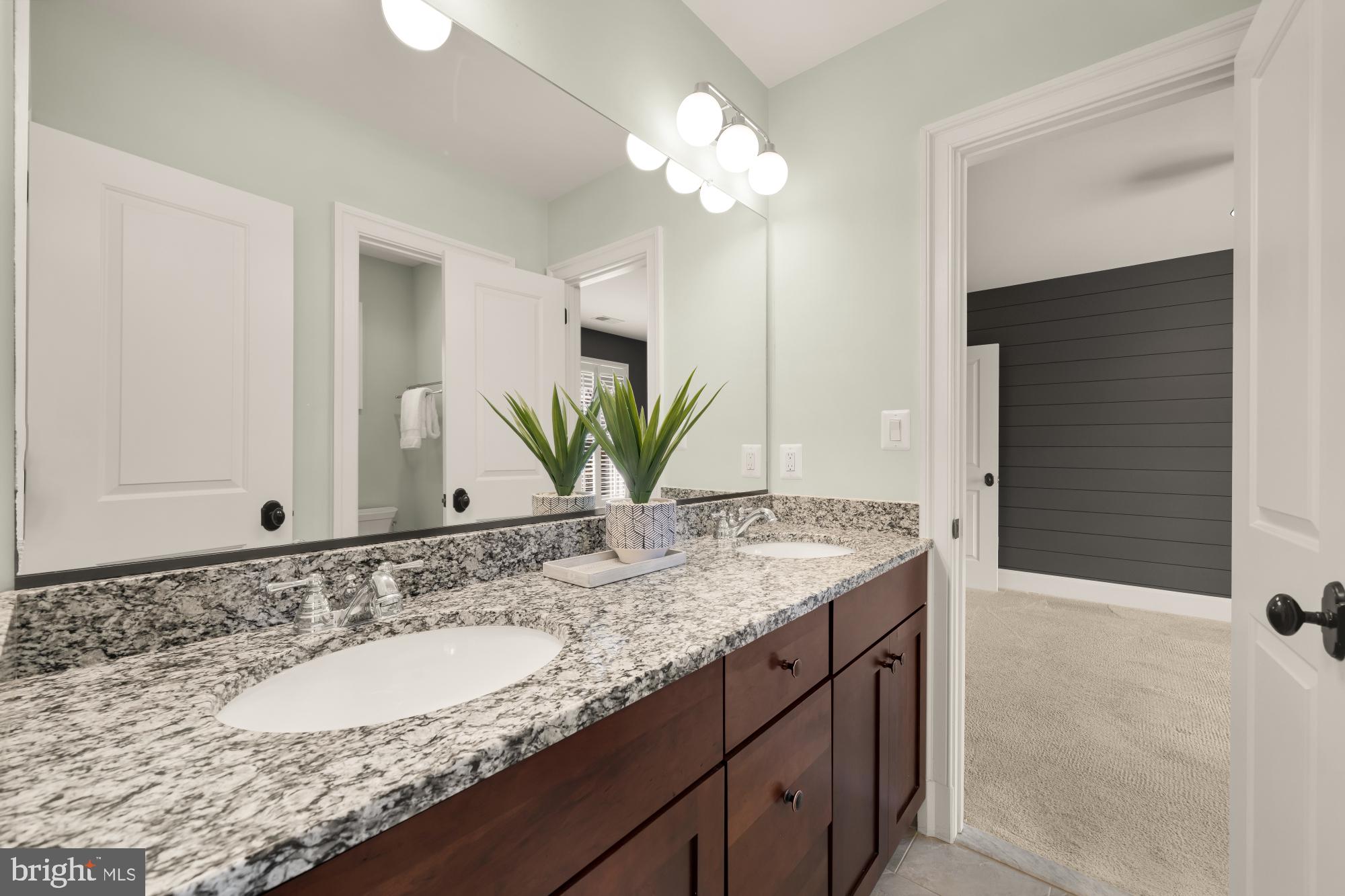 4609 Glenbrook Parkway Bethesda, MD 20814 - Photo 39 of 62 a bathroom with a granite countertop sink and a mirror