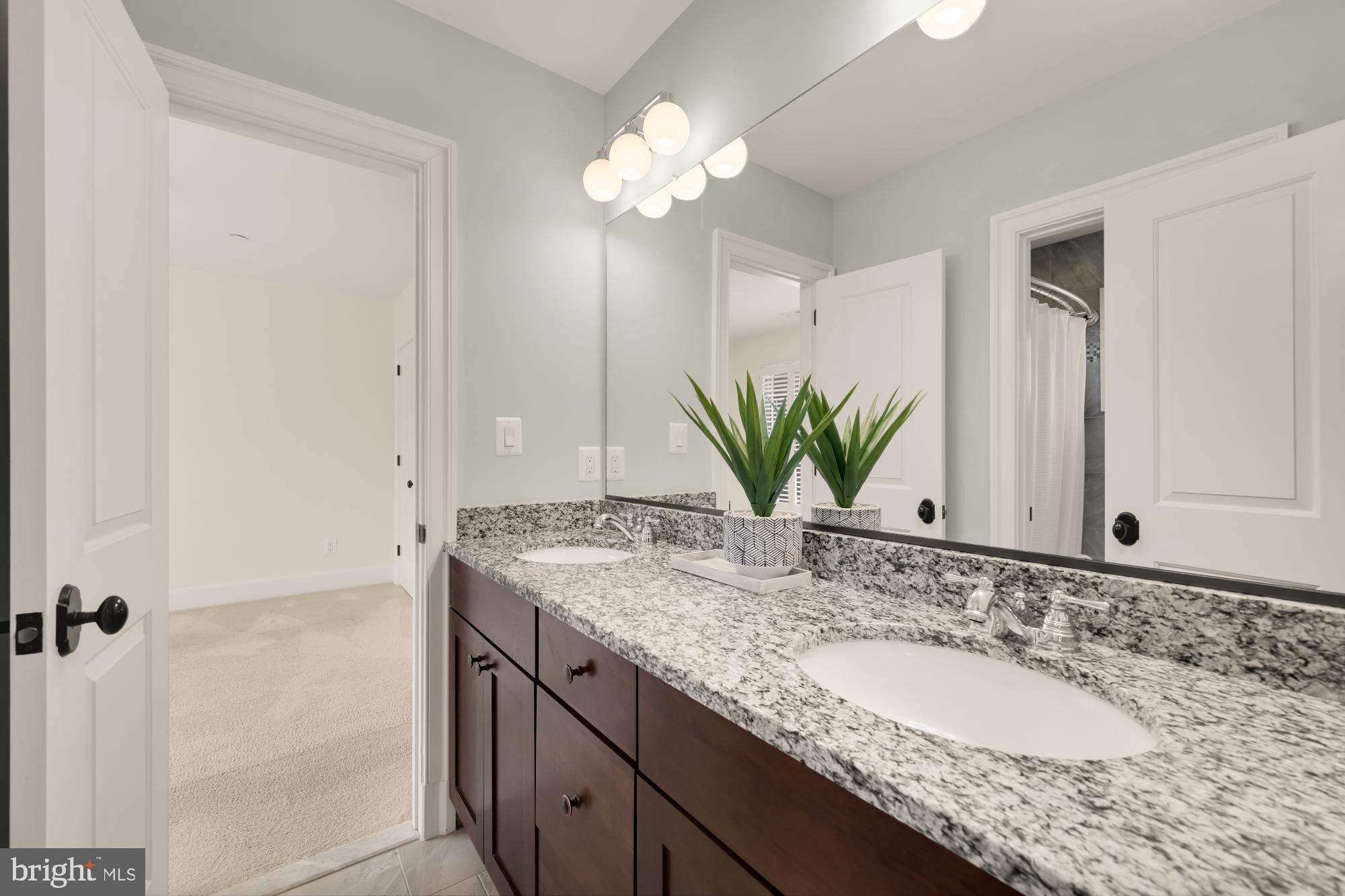 4609 Glenbrook Parkway Bethesda, MD 20814 - Photo 41 of 62 a bathroom with a granite countertop sink and a mirror