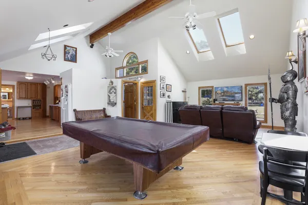 a room with furniture pool table and window