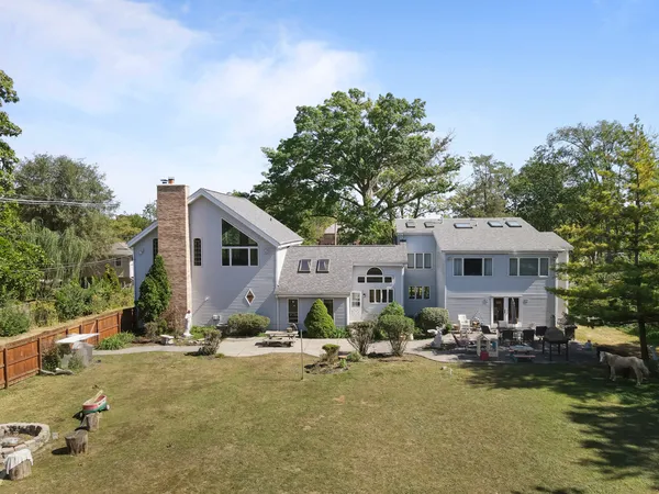 a front view of a house with swimming pool and furniture