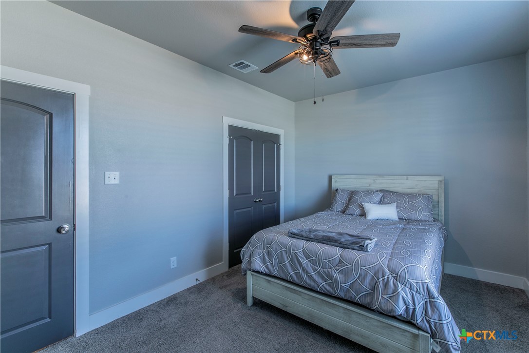 8323 Torrente Drive Temple, TX 76504 - Photo 22 of 30 a bedroom with a bed chandelier and a window