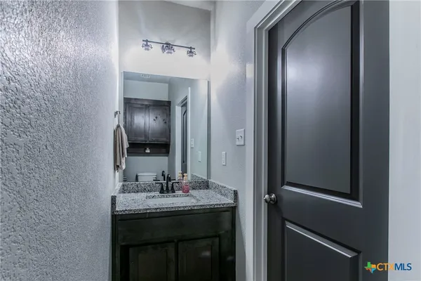 a utility room with wooden floor washer and dryer