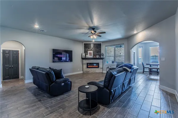 a living room with furniture and wooden floor