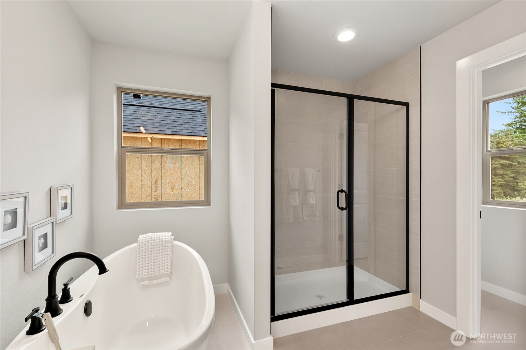 12506 Southeast 256th Place, Unit 8 Kent, WA 98030 - Photo 19 of 26 a bathroom with a bathtub and shower