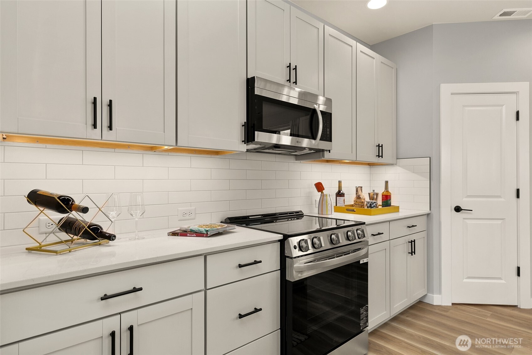 12506 Southeast 256th Place, Unit 8 Kent, WA 98030 - Photo 10 of 26 a kitchen with white cabinets and appliances