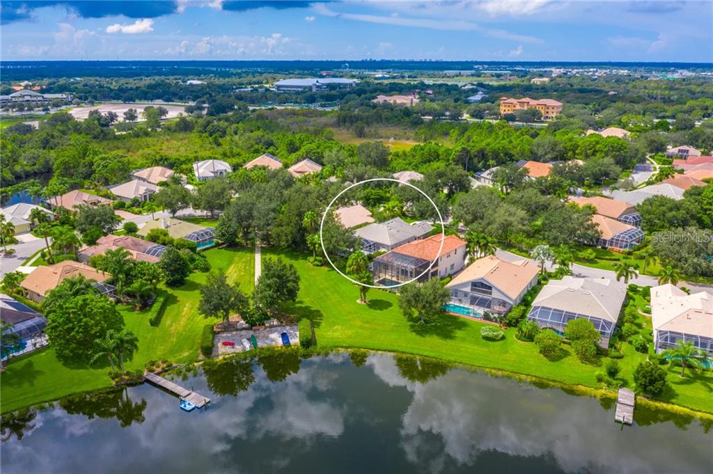 8301 Sailing Loop Lakewood Ranch, FL 34202 - Photo 1 of 1 a view of a lake with a building in the background