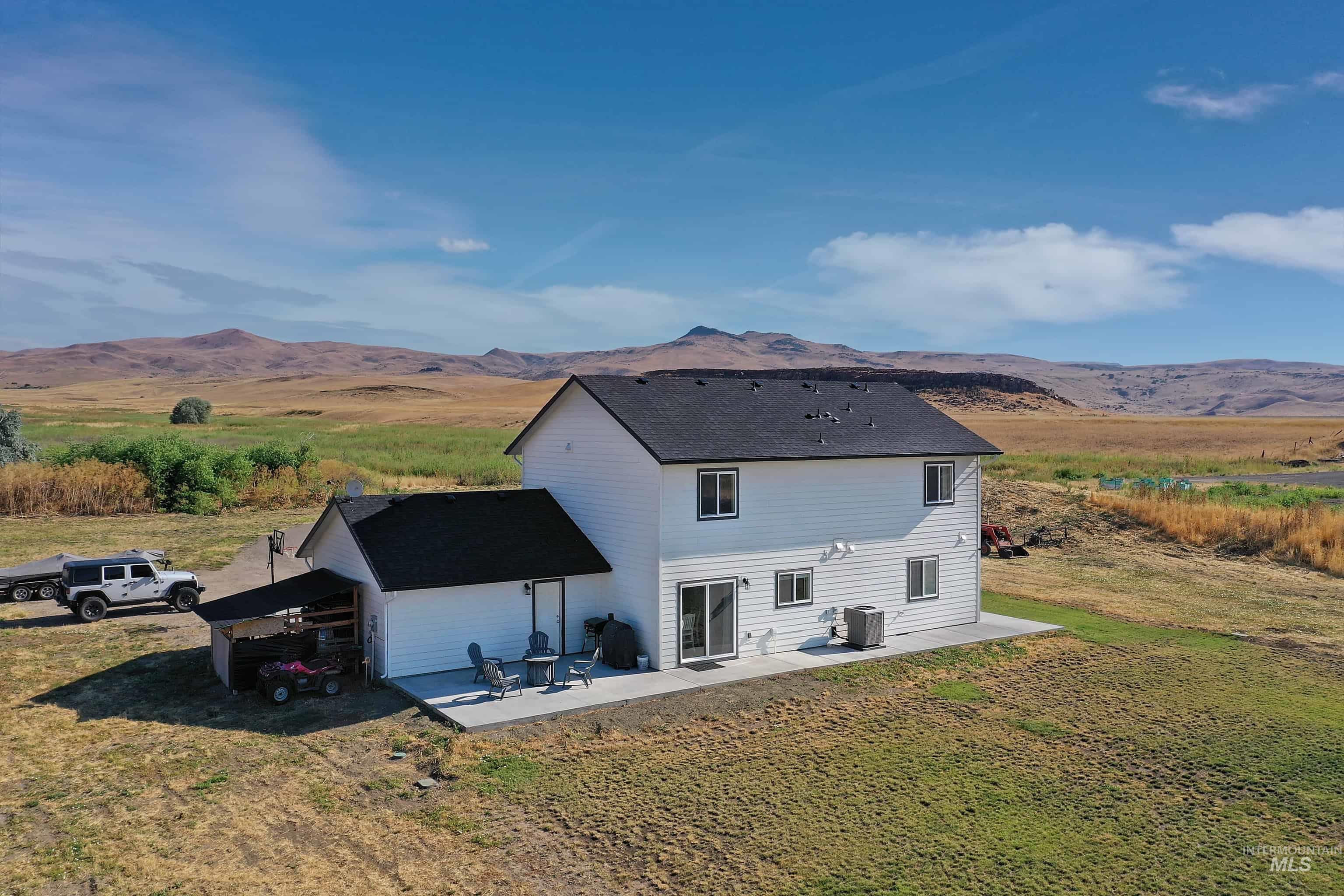 1049 Price Road Weiser, ID 83672 - Photo 38 of 47 Two-story white siding residence featuring a black shingle roof
