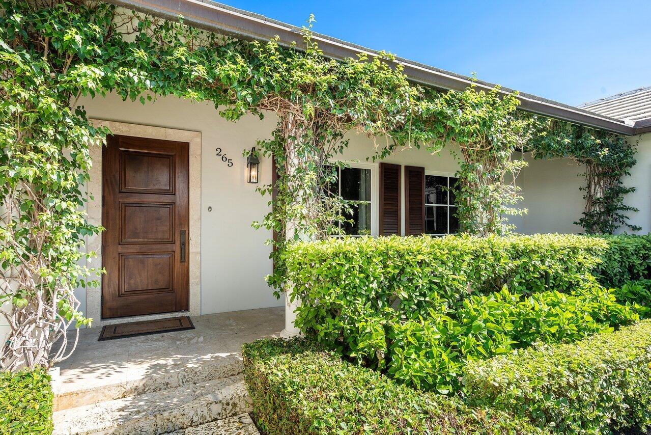 265 List Road Palm Beach, FL 33480 - Photo 2 of 38 front view of a house with a yard