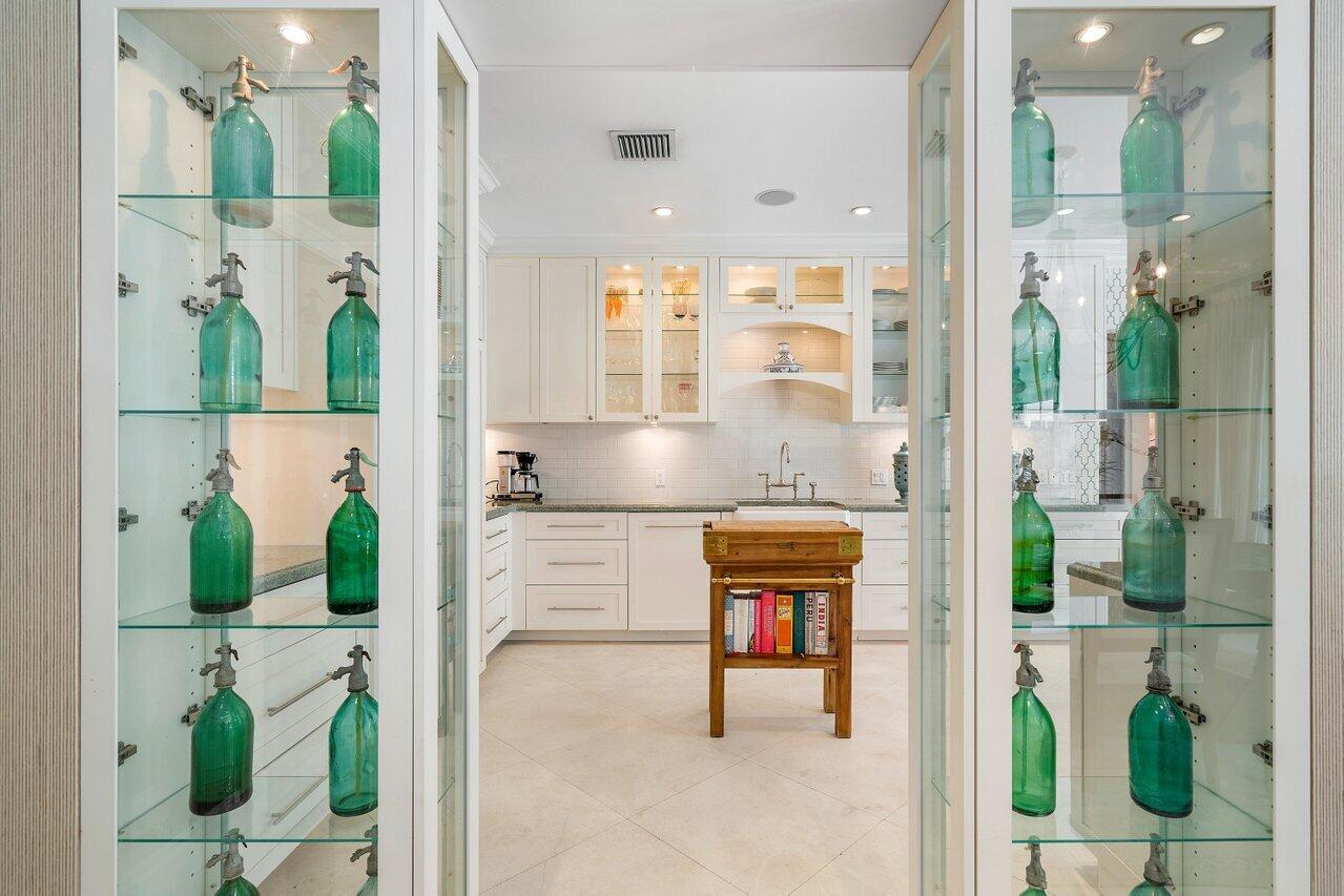 265 List Road Palm Beach, FL 33480 - Photo 14 of 38 a kitchen with stainless steel appliances granite countertop a stove a sink and a dining table