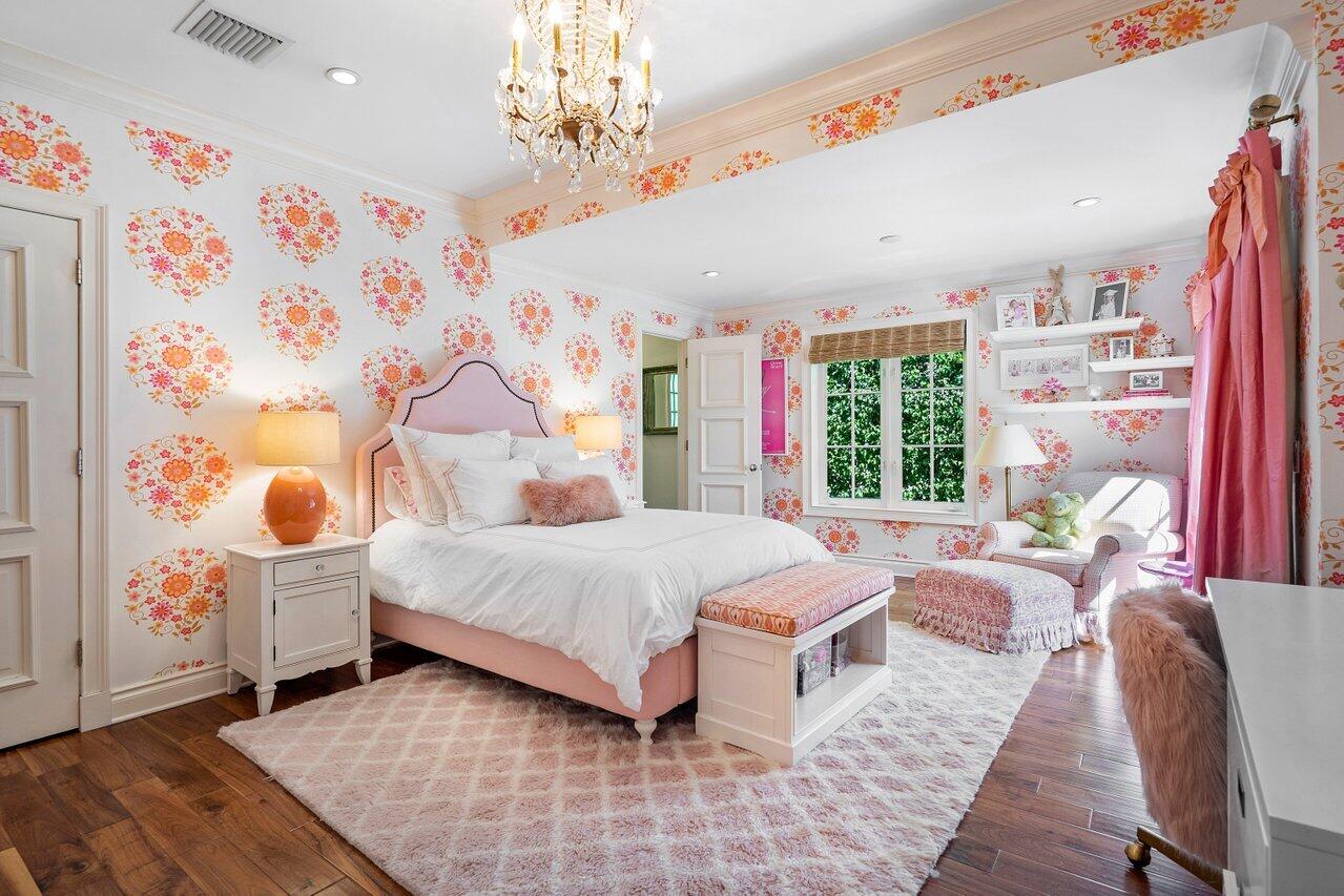 265 List Road Palm Beach, FL 33480 - Photo 23 of 38 a spacious bedroom with a large bed and a chandelier