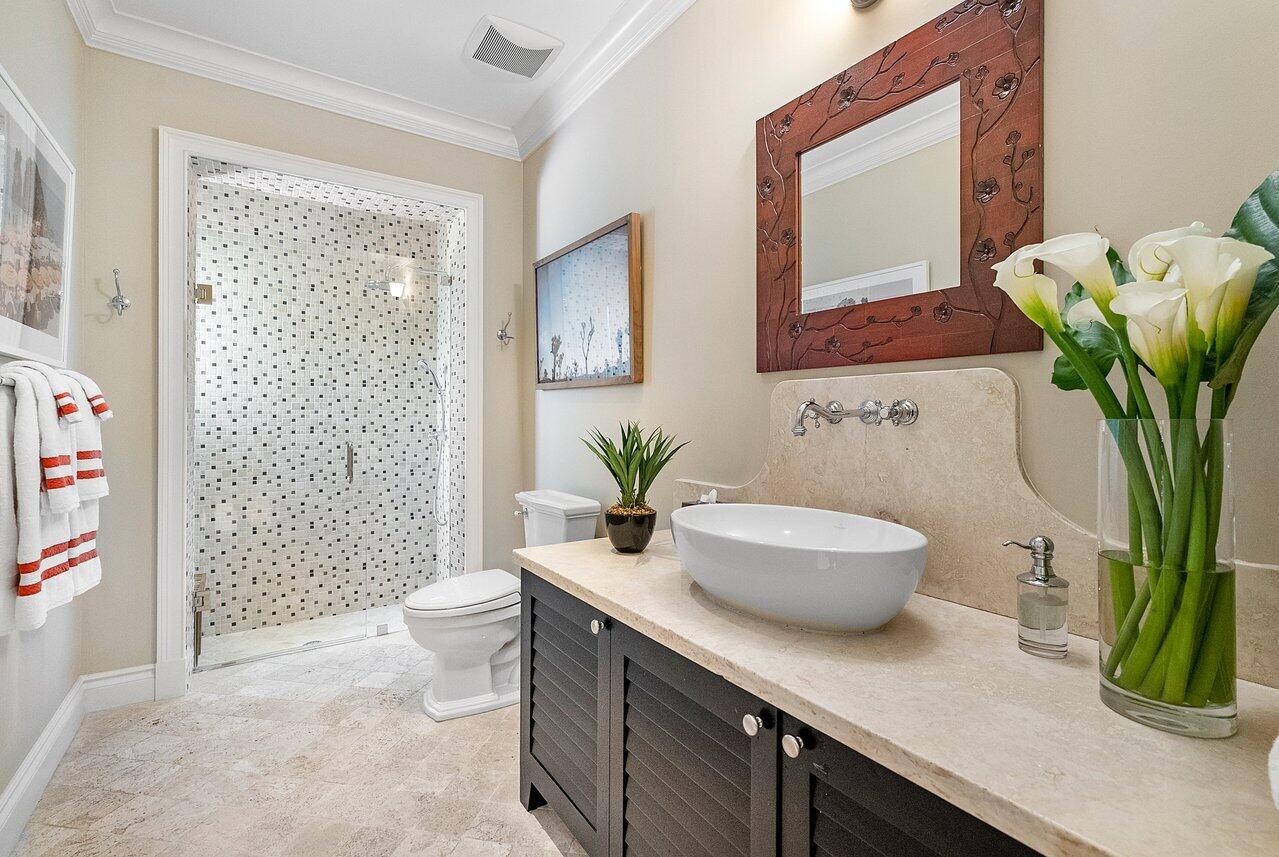265 List Road Palm Beach, FL 33480 - Photo 27 of 38 a bathroom with a granite countertop sink a toilet and a shower
