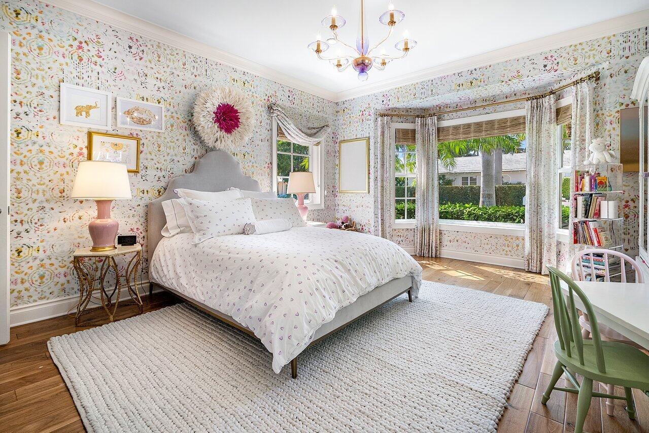 265 List Road Palm Beach, FL 33480 - Photo 28 of 38 a bedroom with a large bed and a chandelier