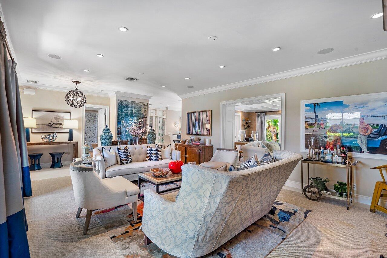265 List Road Palm Beach, FL 33480 - Photo 5 of 38 a living room with furniture and a dining table with wooden floor