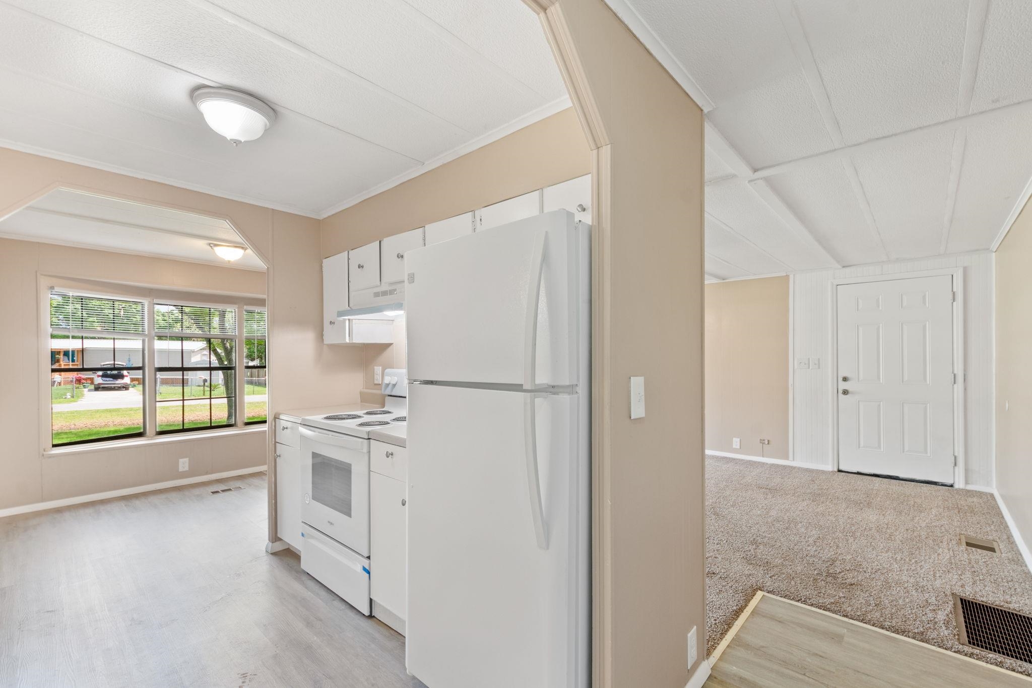 4541 Fourth Avenue St. Augustine, FL 32095 - Photo 16 of 32 a kitchen with white cabinets and white appliances