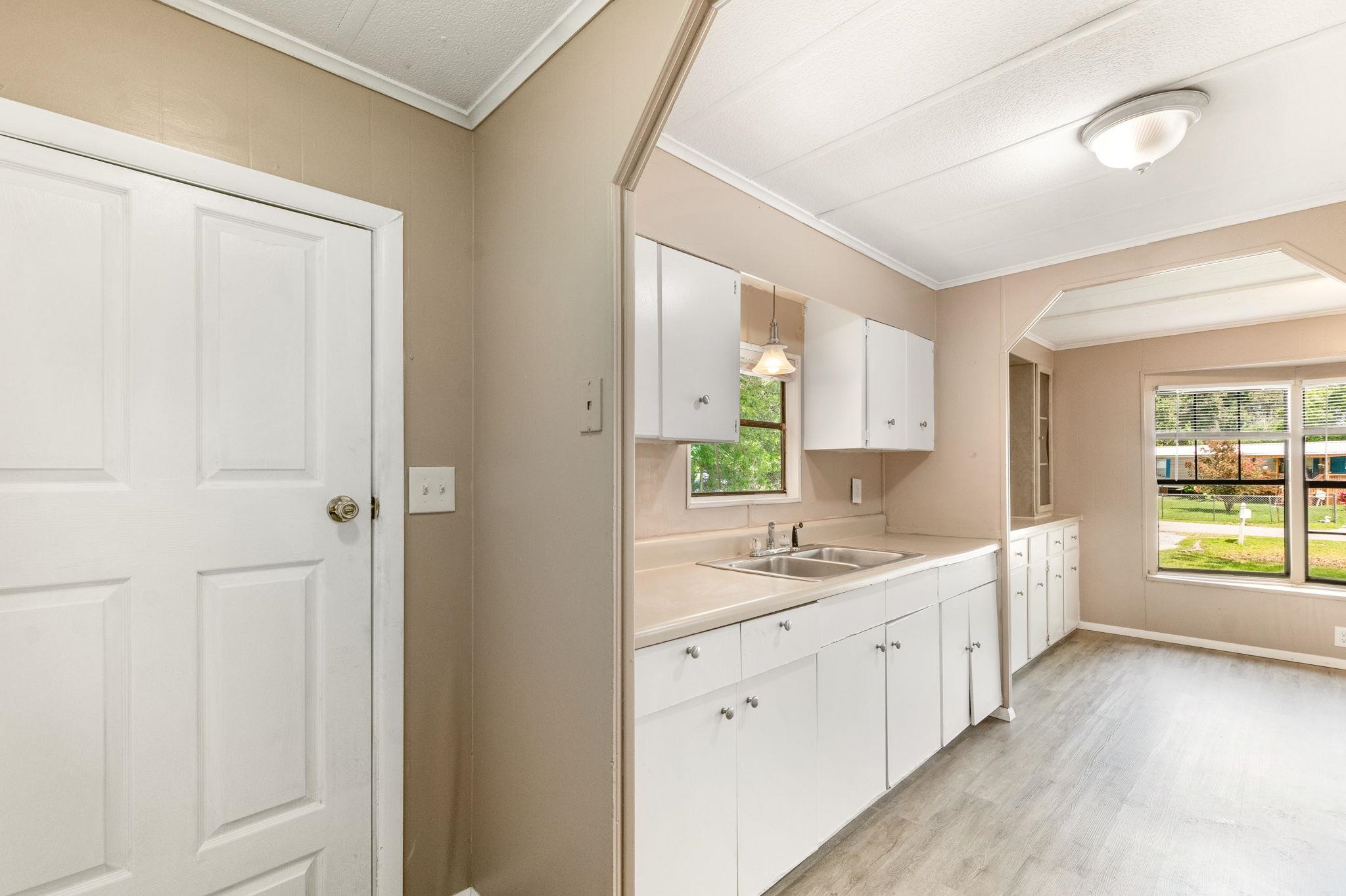 4541 Fourth Avenue St. Augustine, FL 32095 - Photo 17 of 32 a spacious bathroom with a double vanity sink a large mirror a bathtub and window