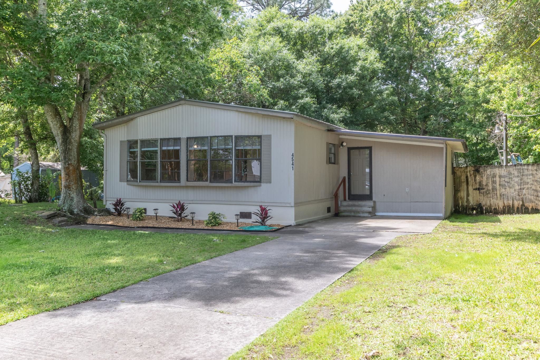 4541 Fourth Avenue St. Augustine, FL 32095 - Photo 2 of 32 a front view of a house with a garden and yard