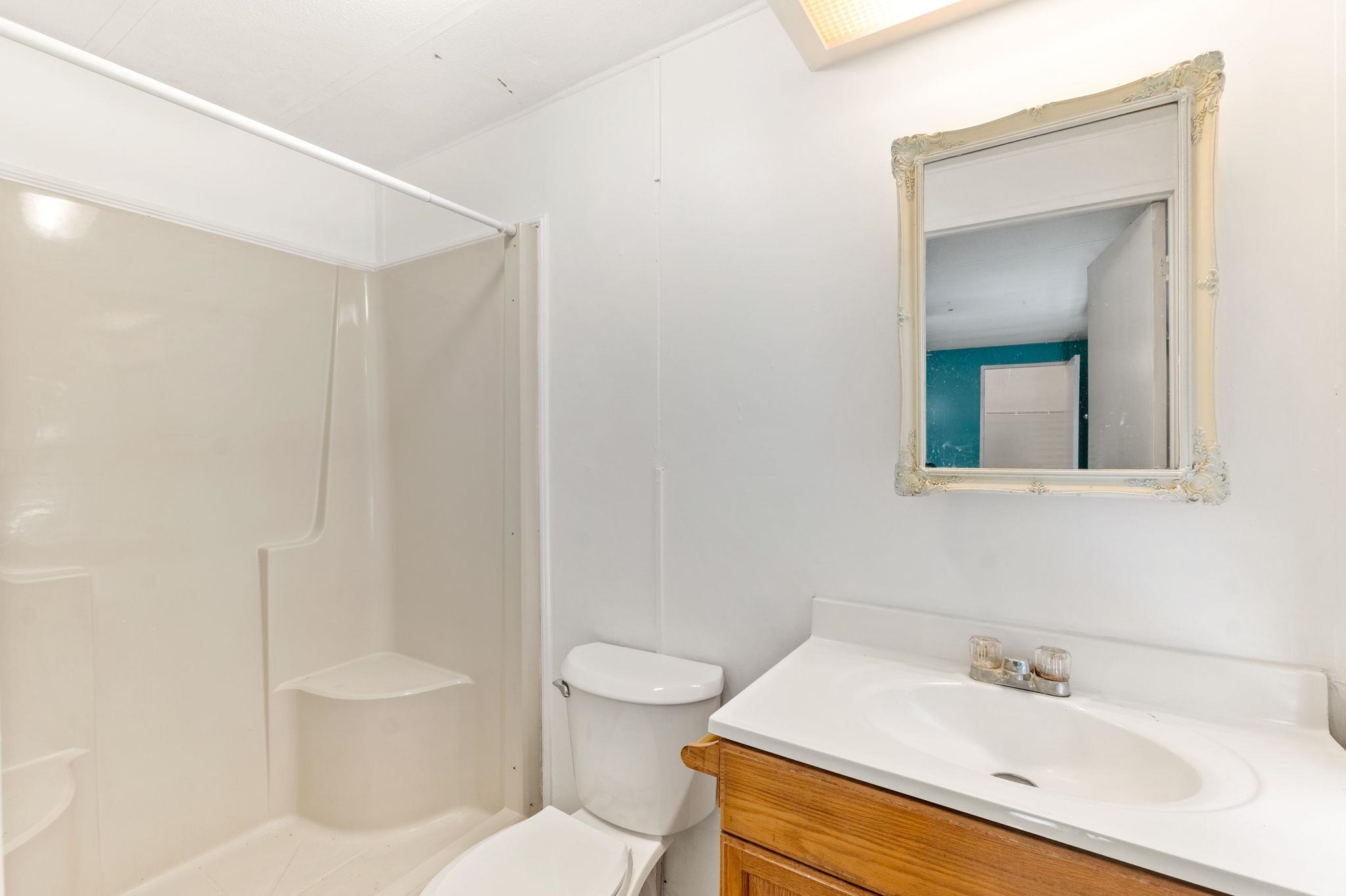 4541 Fourth Avenue St. Augustine, FL 32095 - Photo 22 of 32 a bathroom with a sink a toilet and shower