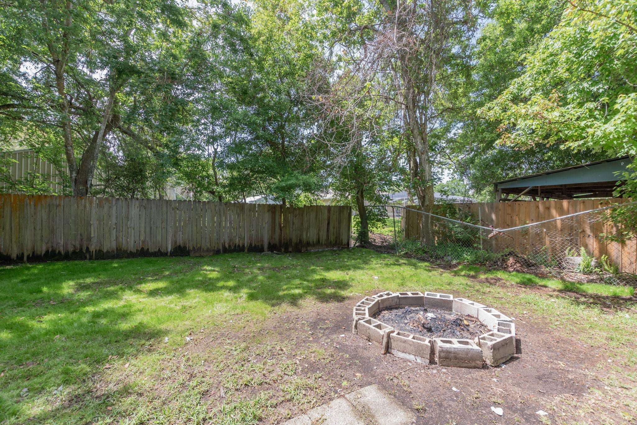 4541 Fourth Avenue St. Augustine, FL 32095 - Photo 30 of 32 a view of a backyard with wooden fence and a large tree