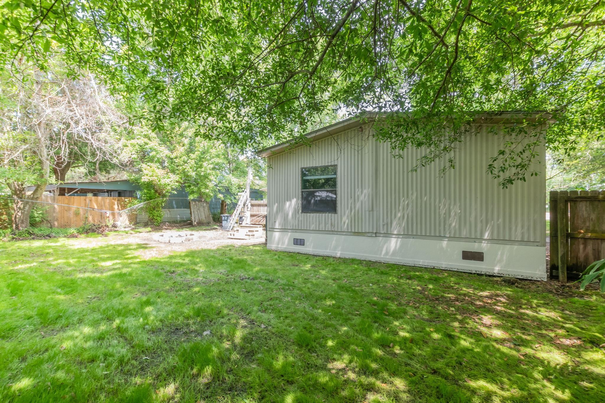 4541 Fourth Avenue St. Augustine, FL 32095 - Photo 31 of 32 a backyard of a house with table and chairs