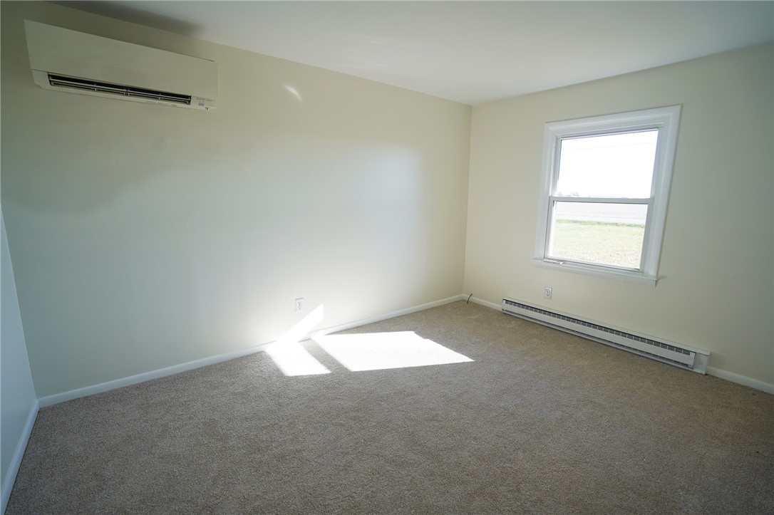 8746 Grubbs-Rex Road Arcanum, OH 45304 - Photo 4 of 38 This bright bedroom features comfortable carpeting and ample natural light, creating a welcoming atmosphere.