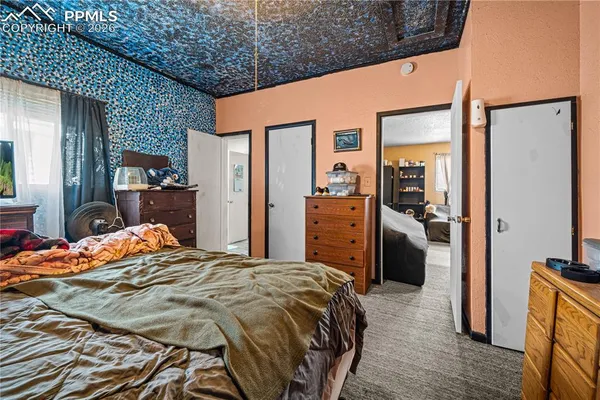 a bedroom with a bed and a large mirror
