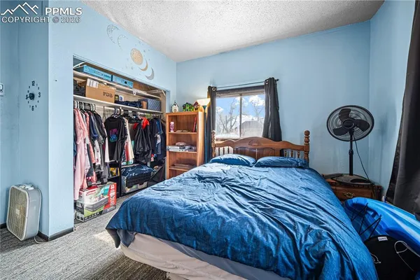 a bed room with a bed and a mirror