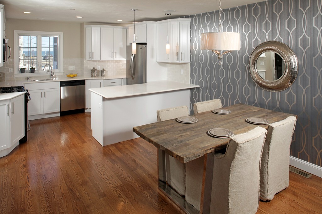 7 Bay Street, Unit 10 Hull, MA 02045 - Photo 5 of 10 a kitchen with a table chairs sink and cabinets