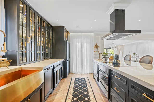 a kitchen with stainless steel appliances a sink stove and cabinets