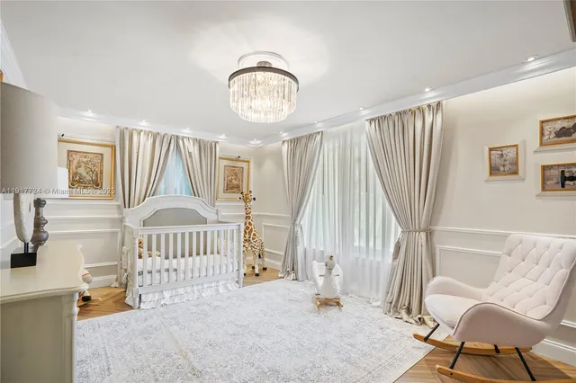 a view of an empty room with wooden floor and windows