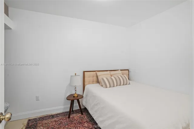 a bedroom with a bed and a chair