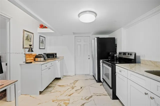 a kitchen with stainless steel appliances a refrigerator stove and sink