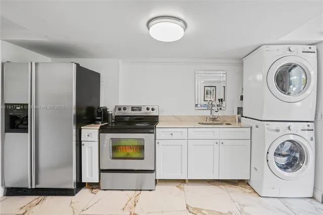 a utility room with sink washer and dryer